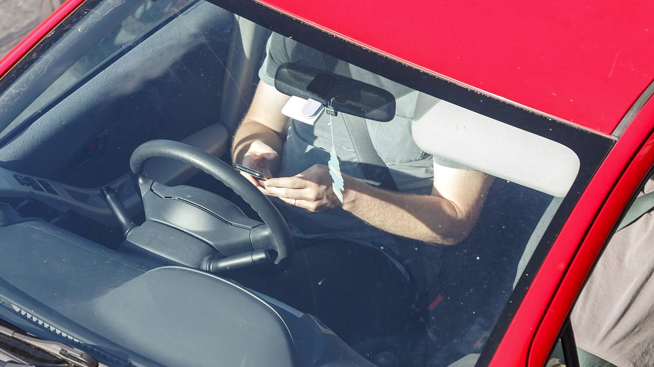 Drivers caught using their phones behind the wheel could lose 10 demerit points and cop a hefty fine. Picture: AAP Image/Josh Woning