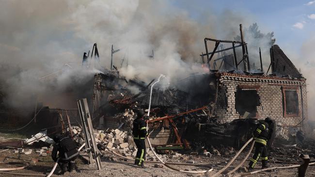 Rescuers fights a fire at a home destroyed during a missile attack in Ukraine’s Kostyatynivka town in the Donetsk region. Picture: AFP