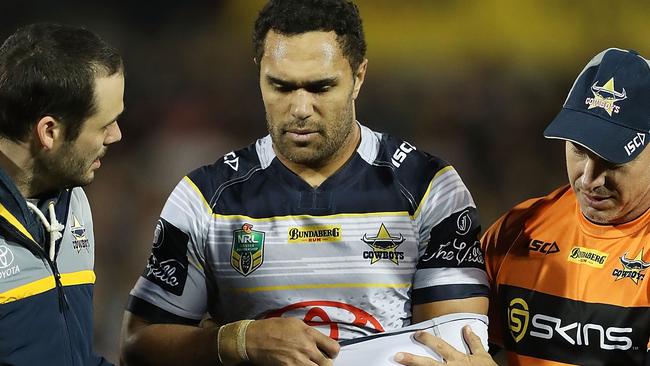 Justin O'Neill is helped from the field after injurying his elbow against Penrith.