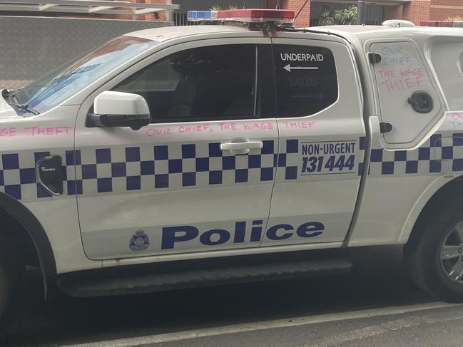 Police cars have been covered with slogans including ‘our chief the wage thief’.