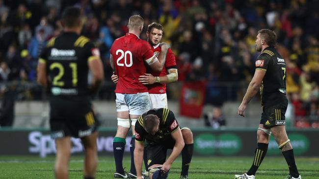 A dejected Dan Biggar of the Lions is consoled by teammate George Kruis.