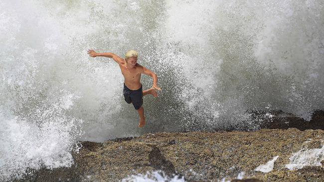 A thrillseeker jumps for safety at Snapper Rocks. Picture: Adam Head