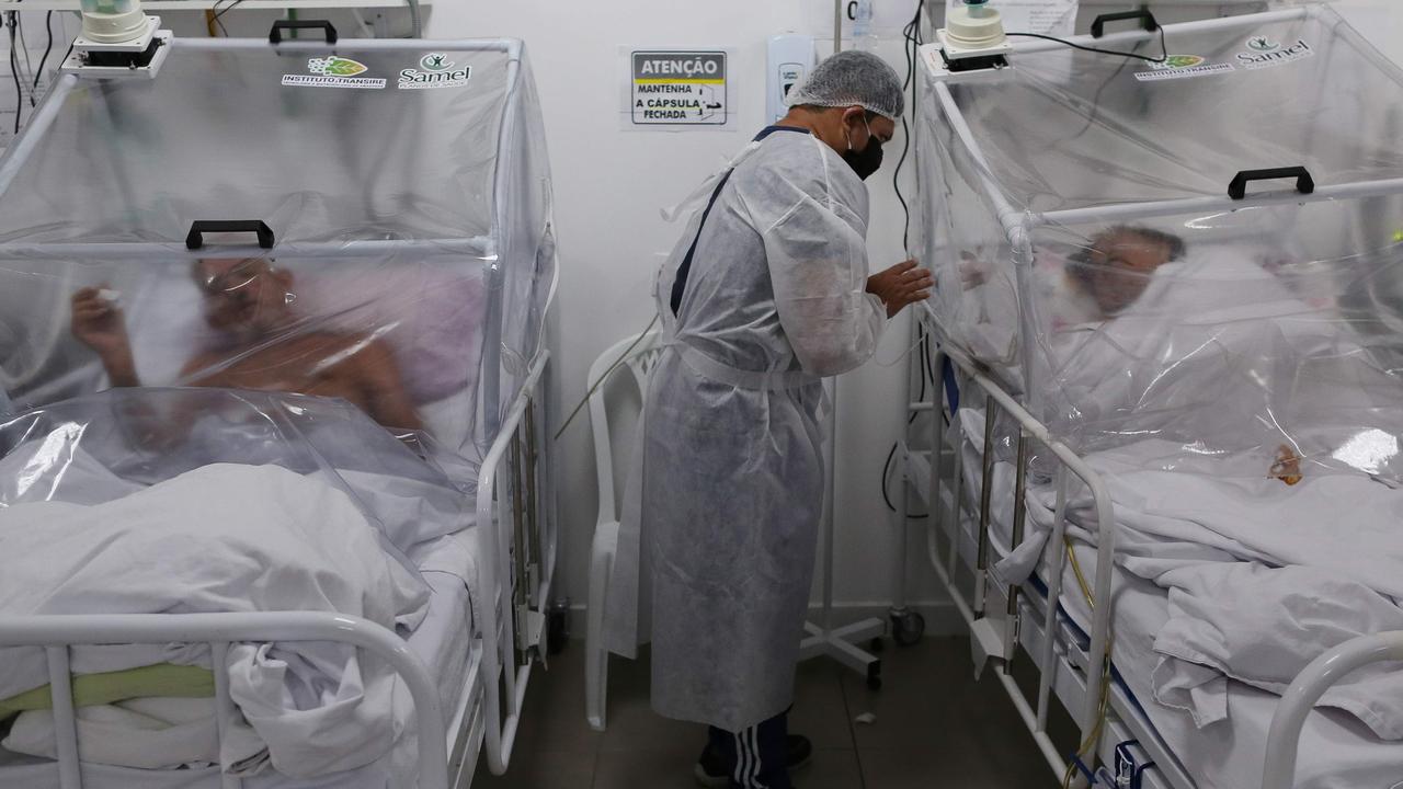 A health worker is seen next to patients in the Intensive Care Unit for COVID-19 of the Gilberto Novaes Hospital in Manaus, Brazil. Picture: AFP