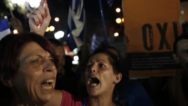 Supporters of the No vote chant slogans after the results of the referendum at Syntagma square in Athens, Sunday, July 5, 2015. Voters in Greece resoundingly rejected creditors' demands for more austerity in return for rescue loans Sunday, backing Prime Minister Alexis Tsipras, who insisted the vote would give him a stronger hand to reach a better deal. (AP Photo/Petros Giannakouris)