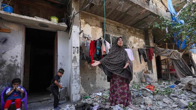 A Palestinian woman outside the rubble of her home which was hit at dawn in Israeli bombardment of Nuseirat city. Picture: AFP