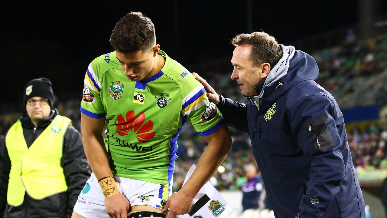 Raiders coach Ricky Stuart (R) talks with Joseph Tapine