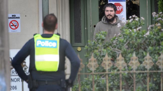 Police and medical staff outside Hambleton House, a boarding house for homeless people in Melbourne’s Albert Park. Picture: Tony Gough