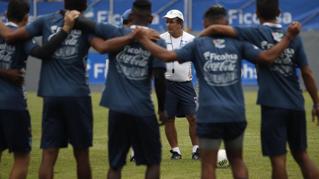 Honduras head coach Jorge Luis Pinto, center, talks to his players.