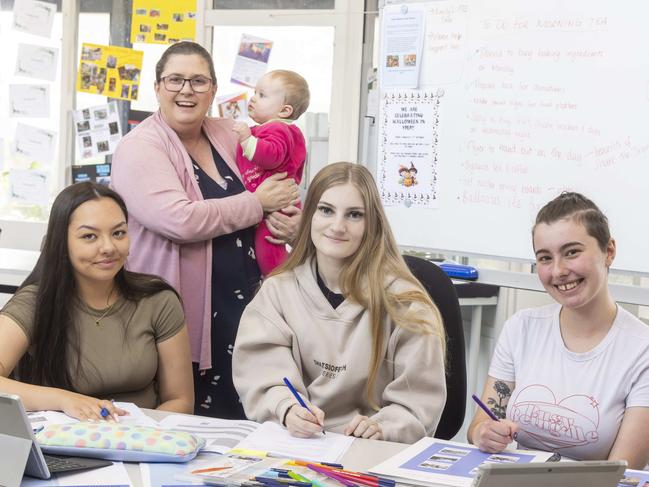 Early Parenting Support Worker Donna Strickleton looks after the babies while the young mothers do their work. Picture: Wayne Taylor