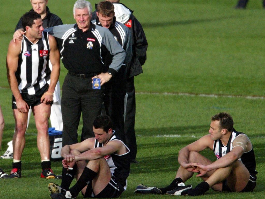 Collingwood coach Mick Malthouse in tears with Paul Licuria, Alan Didak and Anthony Rocca after losing the 2002 Grand Final to Brisbane.