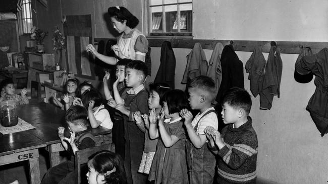 Aiko Sumoge, an assistant teacher, leads a kindergarten class to sing an English folk song at the internment relocation center for Japanese Americans in Tulelake, California, in 1943. 