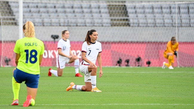 USA Women's soccer player Tobin Heath kneels with teammates and members team Sweden before a Group G game at the 2020 Tokyo Olympics. Picture: Getty