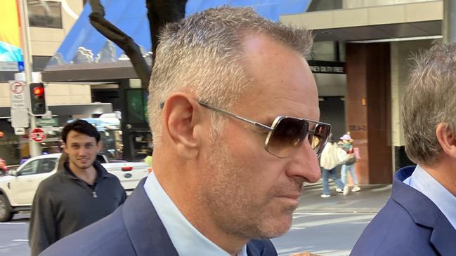 Brett Trevillian (left, foreground) leaves Downing Centre Local Court on July 28. Picture: Eliza Barr