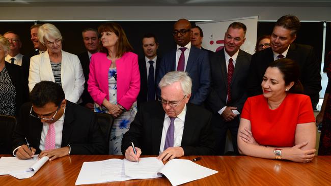 Sam Vora of Adani, left, David Overall of Downer Mining and Queensland Premier Annastacia Palaszczuk as letters were signed for the mine to go ahead yesterday. Picture: Scott Radford-Chisholm