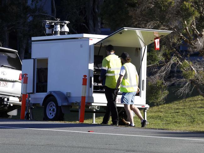 Workmen setting up lights and cameras on the Gold Coast Highway on Thursday afternoon in preparation for the erection of barricades at the border. Picture: Tertius Pickard