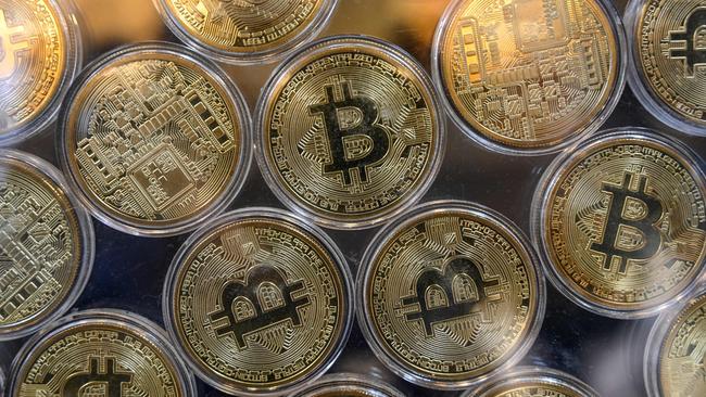 Physical imitation of Bitcoins are pictured at a cryptocurrency exchange branch. Picture: AFP