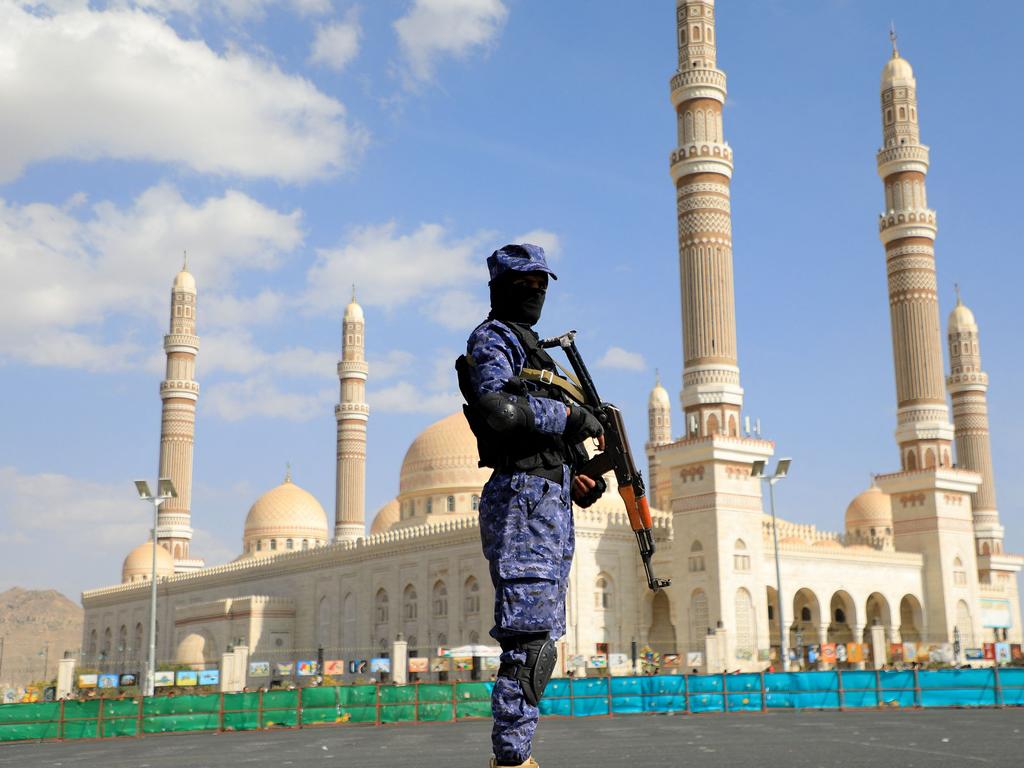 A Houthi fighter stands guard in front of Sanaa's Al-Saleh Grand Mosque.