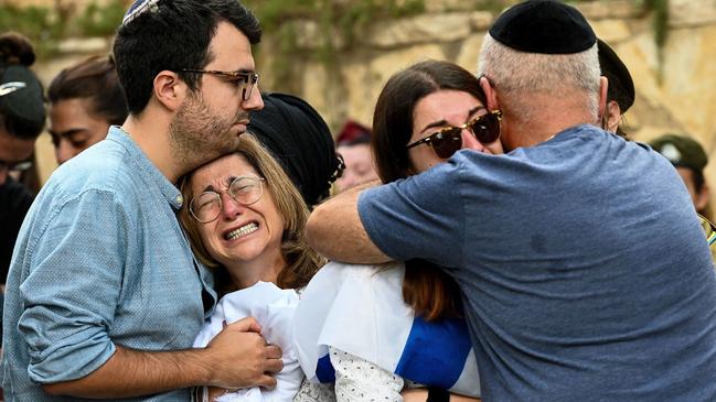 The family of a 23-year-old soldier killed in a firefight with Hamas terrorists at a kibbutz near the Gaza border mourn at the Mount Herzl military cemetery in Jerusalem. Picture: Getty Images