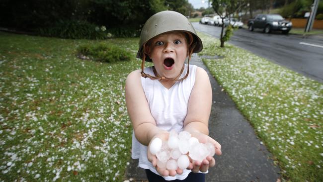 Ella 8, with huge hailstorms in Templestowe. Ella said: “I wished for a white Christmas, but not this.” Picture: David Caird