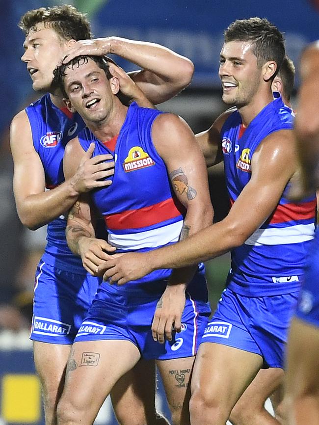 Tom Liberatore is congratulated after kicking a goal.