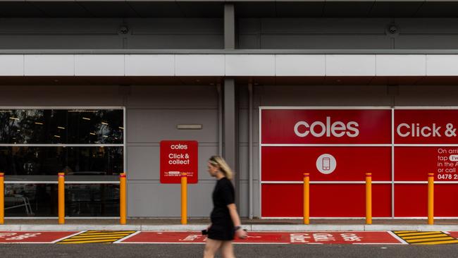 A customer walks past a Coles supermarket in Melbourne.