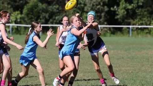 Charlotte Cran pressures an opponent for Wynnum Vikings.