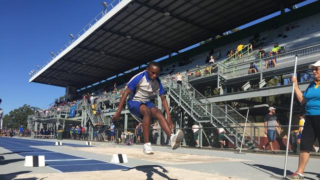 Isaac Pascal leaping in the long jump pit.