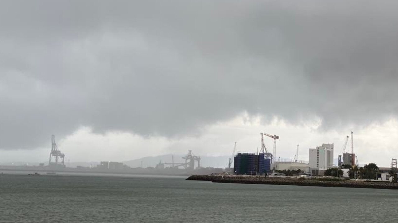 Dark clouds and rain close in on the Port of Townsville on Saturday.