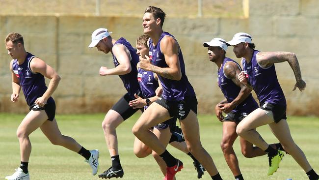 Rory Lobb, middle, runs with new teammates at Fremantle training.