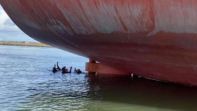 Police divers searching the waters near the boat’s hull. Picture: NSW Police