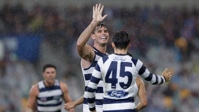 Tom Hawkins and Brad Close celebrate a goal in the wet against Brisbane in Round 6 last year. Picture: Russell Freeman/AFL Photos via Getty Images.