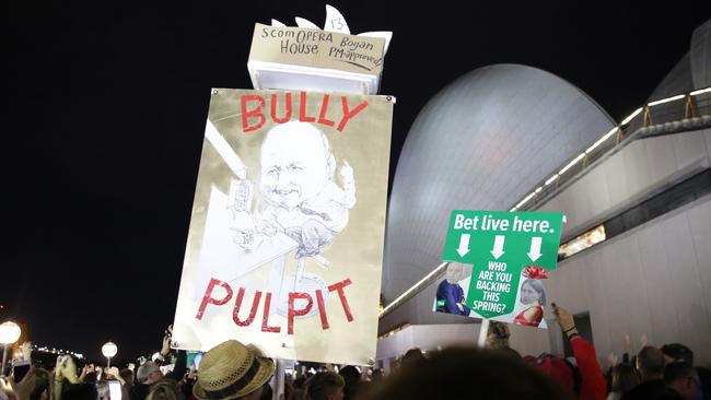 Protesters at the Sydney Opera House on Tuesday night with placards renaming the iconic building ‘Bogan House’ and ‘ScomOpera’. Picture: Christian Gilles