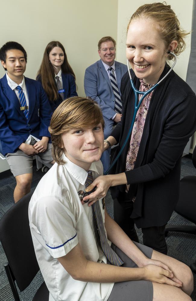 Billy Smith gets his blood pressure checked by GP Dr Natasha Duncan as classmates Eden Dot, Lily Crittenden and principal Ross Bailey look on.