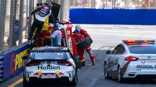 Shane van Gisbergen (fence in blue) rushed to help Scott McLaughlin after a crash at the V8 Supercars Vodafone Gold Coast 600. Picture: steinhouradam (Instagram)