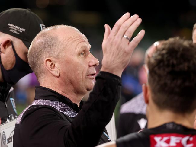 ADELAIDE, AUSTRALIA - AUGUST 14: Senior coach Ken Hinkley of the Power speaks to his players during the 2021 AFL Round 22 match between the Port Adelaide Power and the Carlton Blues at Adelaide Oval on August 14, 2021 in Adelaide, Australia. (Photo by James Elsby/AFL Photos via Getty Images)