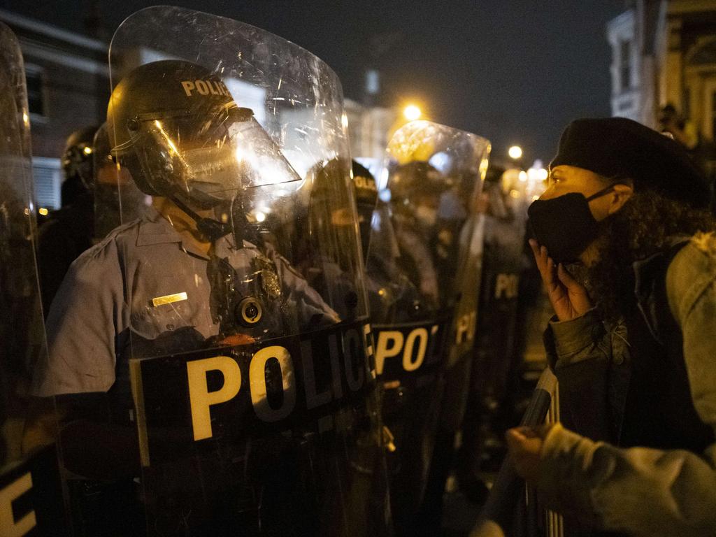 A demonstrator confronts police officers forming a barricade line. Picture: Mark Makela/Getty Images/AFP