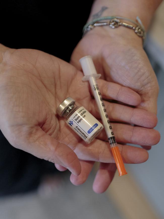 Kait Handler holds her daughter, Birdie's, medication. Picture: Sarah Blesener for WSJ