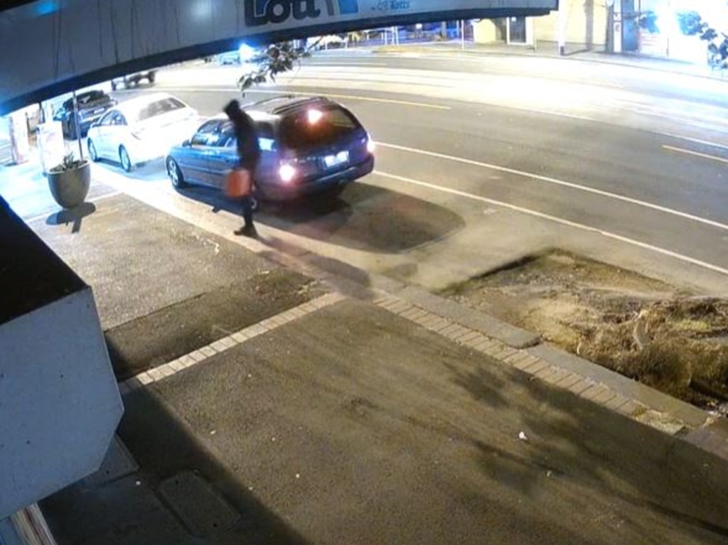 CCTV footage captures a man carrying a jerry can outside the Racecourse Rd tobacconist. Picture: Supplied