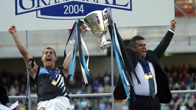 Warren Tredrea and Mark Williams with the 2004 AFL premiership trophy.