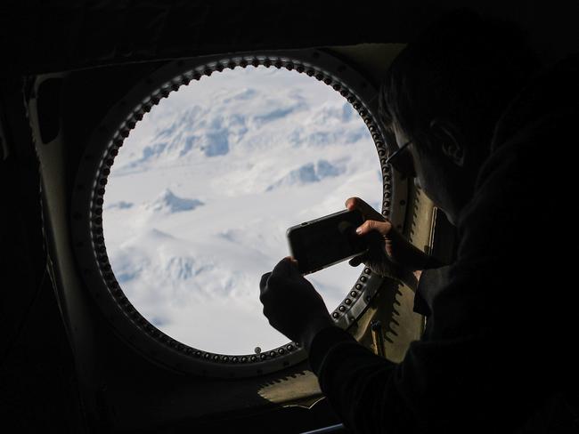 NASA Operation IceBridge project scientist Nathan Kurtz photographs from NASA's research aircraft in the Antarctic Peninsula region. NASA's Operation IceBridge has been studying how polar ice has evolved over the past nine years. Picture: AFP