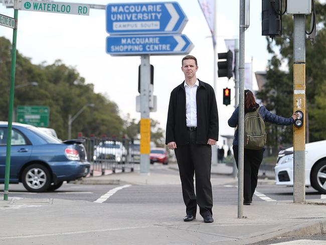 Journalist Steven Deare waits to cross the road at the Lane Cove Rd - Waterloo Rd intersection outside Macquarie Park train station. Picture: Danny Aarons