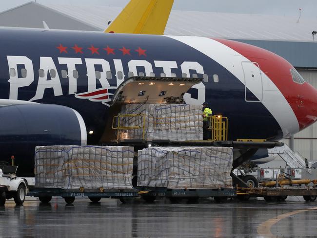 Palettes of N95 respirator masks are off-loaded from the New England Patriots football team's customised Boeing 767 jet at Logan Airport in Boston, after returning from China. Picture: AP