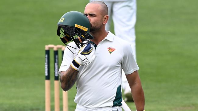 Jake Weatherald of Tasmania kisses his helmet after scoring a century during the Sheffield Shield match between Tasmania and New South Wales. Picture: Steve Bell/Getty Images