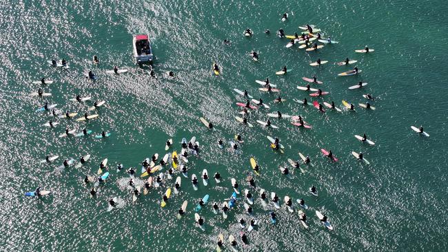 Hundreds gathered to farewell Bill Carey during a paddle out at The Bluff at Alexandra Headland. Picture: John Anderson