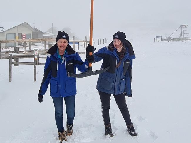 Ben Lomond Snow Sports staff Jeanette Elms and Mahalia Smith enjoy the heavy snowfall on Tuesday.