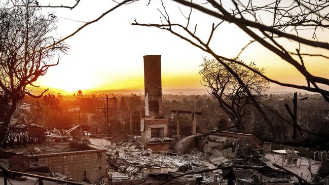 The sun rises behind a home destroyed by the Palisades Fire in the Pacific Palisades. Picture: AP Photo