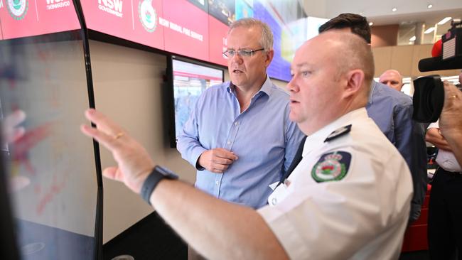 Scott Morrison is briefed by NSW RFS commissioner Shane Fitzsimmons in the Sydney control room on Sunday. Picture: AAP