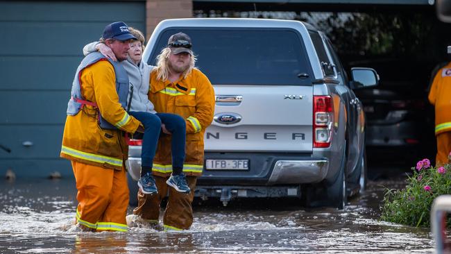 An elderly woman and her husband are rescued from their flooded Rochester home. Picture: Jason Edwards