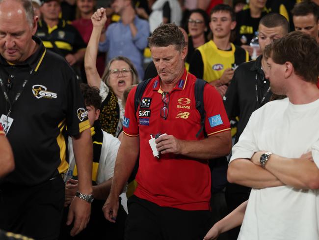 MELBOURNE, AUSTRALIA - APRIL 19: Damien Hardwick, Senior Coach of the Suns leaves as Tigers fans celebrate after the round six AFL match between Richmond Tigers and Gold Coast Suns at Marvel Stadium, on April 19, 2025, in Melbourne, Australia. (Photo by Daniel Pockett/Getty Images)