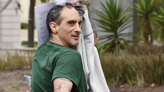 Jason Caudullo leaving Geelong police station wearing green t-shirt and grey pants.